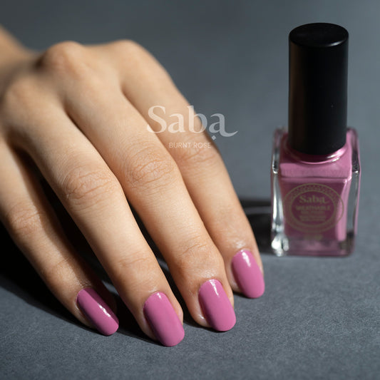 Saba Burnt Rose is a breathable nail polish in a soft, rose petal-inspired pink. Vegan, toxin-free, and beautifully wearable for all skin tones.